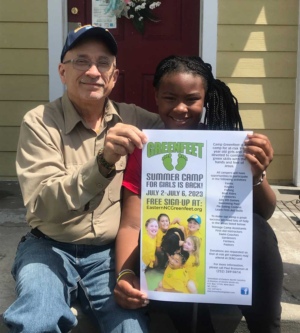 Displaying a poster for Camp Greenfeet are founder, Paul Branaman, guardian ad litem for Ciera Jones, who is one of this year’s campers.