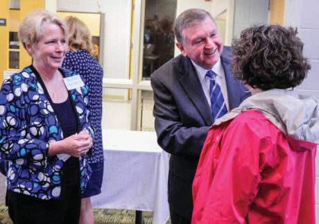 Pamlico Community College President Dr. Jim Ross, center, and his wife, Pam, left, greet a guest at the college’s inaugural Non-profit Leadership Breakfast in 2017. Contributed photo