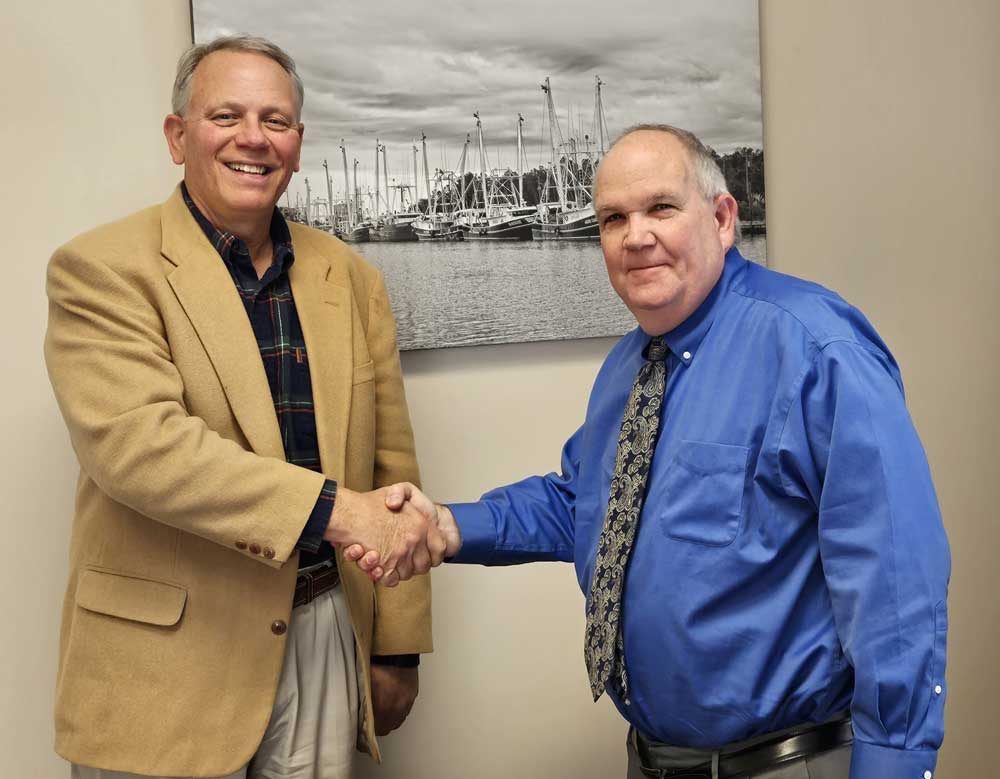 Bill Fentress (left) receives congratulations from Tim Buck, County Manager.